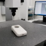 Operator checking the appearance of ABS consumer product housing after molding