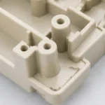 Close-up detail of injection molded plastic part with bosses ribs and molded features