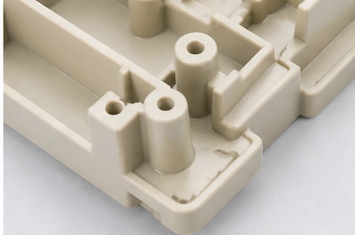 Close-up detail of injection molded plastic part with bosses ribs and molded features