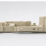 Side view of injection molded plastic part showing wall thickness and molded structure