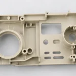 Top view of injection molded plastic functional part showing holes slots and internal ribs