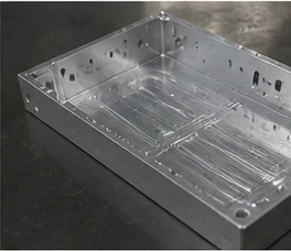 Side view of CNC machined aluminum housing with clean holes, slots, and precision machined surfaces