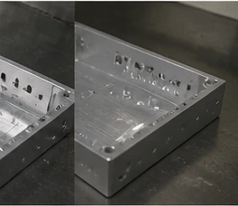 Close-up detail of CNC machined aluminum housing showing inner structure, holes, and machined finish