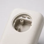 Close-up of round hole and inner snap-fit details on ABS consumer product housing
