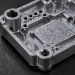 Close-up of a zinc alloy die cast housing showing holes, ribs, and bosses