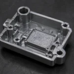 Close-up of a zinc alloy die cast electronic component with mounting bosses